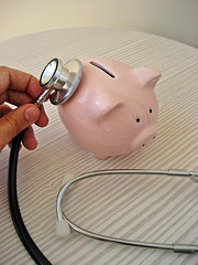 stethoscope and piggy bank