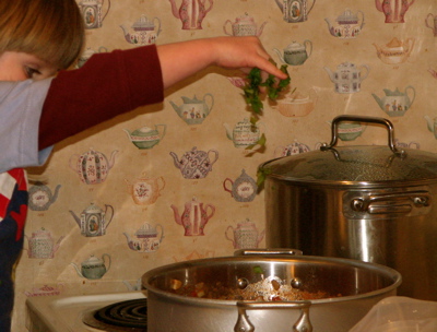 My gal tossing in fresh basil