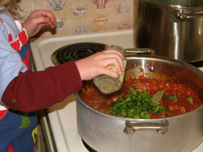 My gal tossing in dried oregano